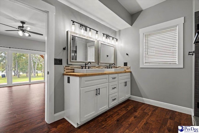 bathroom featuring wood-type flooring, vanity, and ceiling fan