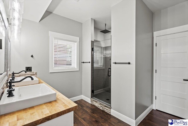 bathroom featuring vanity, a shower with shower door, and hardwood / wood-style floors