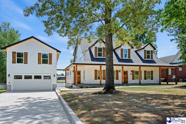 view of front of home with a porch and a garage