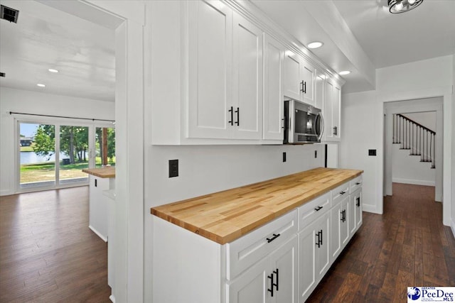 kitchen featuring white cabinetry, dark hardwood / wood-style floors, and wood counters