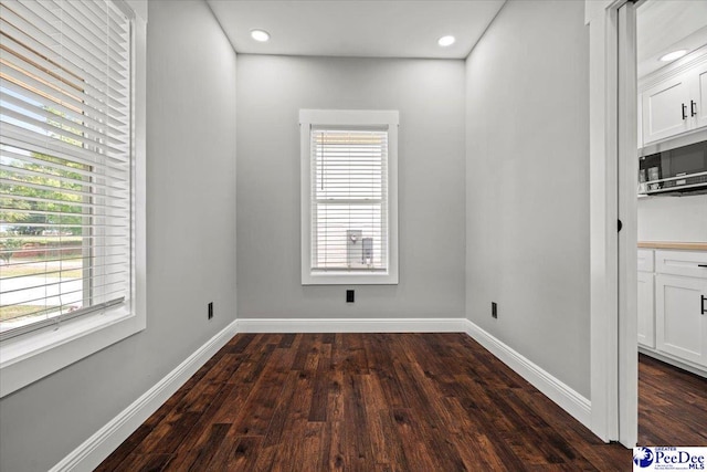 unfurnished dining area featuring dark hardwood / wood-style flooring