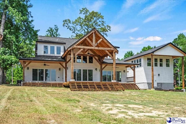 rear view of house featuring a yard and ceiling fan