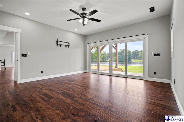 spare room with ceiling fan and dark hardwood / wood-style flooring