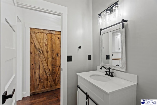 bathroom featuring hardwood / wood-style flooring and vanity