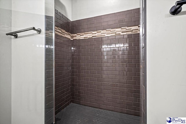 bathroom with a tile shower