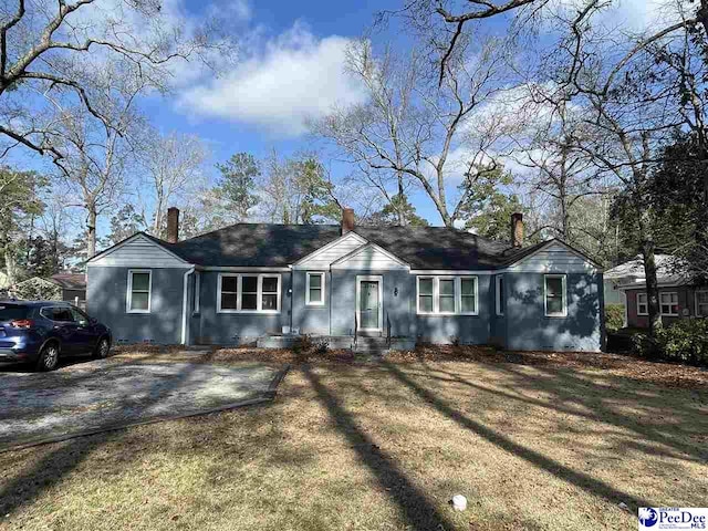 single story home featuring a front lawn