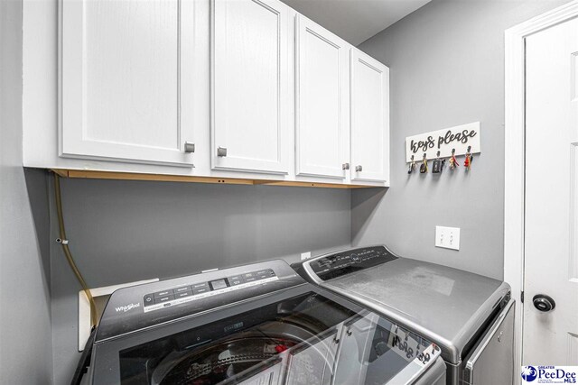 868 Moonshadow Ln, Darlington, SC 29540 - laundry area with washing machine and clothes dryer and cabinet space