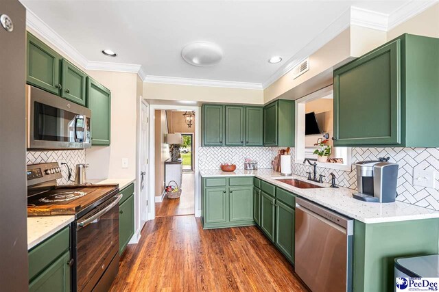 868 Moonshadow Ln, Darlington, SC 29540 - kitchen featuring stainless steel appliances, backsplash, ornamental molding, dark wood-style flooring, and recessed lighting