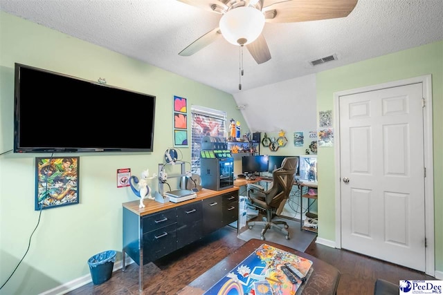 office space featuring a ceiling fan, dark wood-style flooring, visible vents, and a textured ceiling