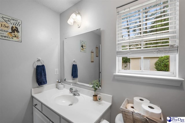 half bathroom with toilet and vanity