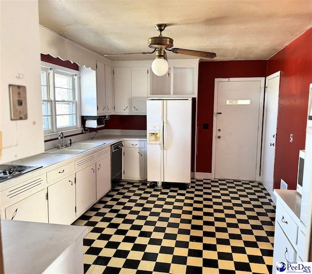 kitchen featuring dark floors, white cabinets, a sink, and black appliances