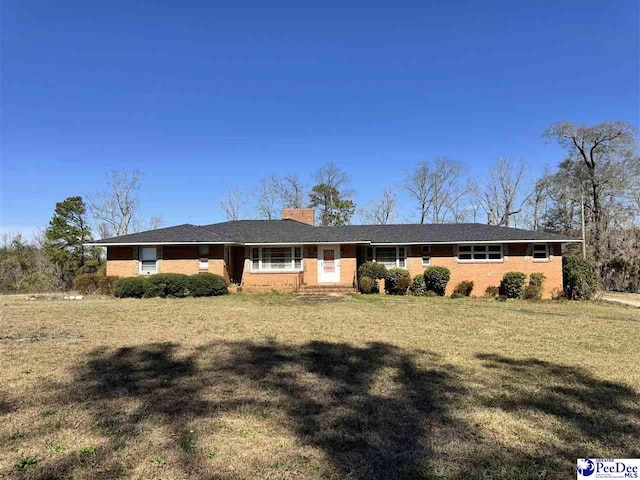 1316 Sunset Dr, Darlington, SC 29532 - ranch-style house with a front yard, brick siding, and a chimney