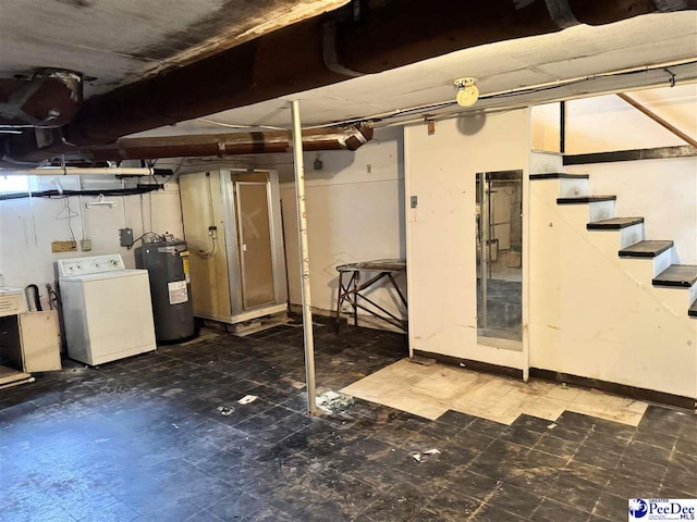 unfinished basement featuring stairs, dark floors, washer / clothes dryer, and electric water heater