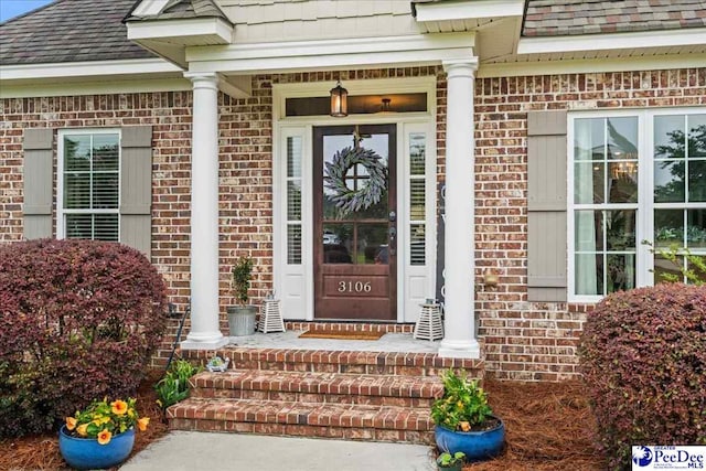 3106 Wainwright Ct, Florence, SC 29501 - doorway to property featuring brick siding and roof with shingles