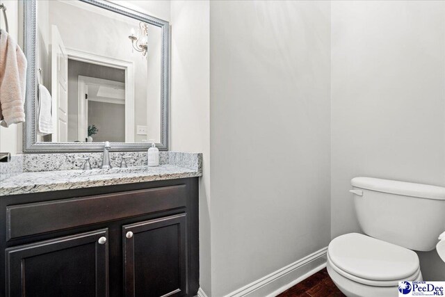 3106 Wainwright Ct, Florence, SC 29501 - bathroom featuring toilet, vanity, wood finished floors, and baseboards