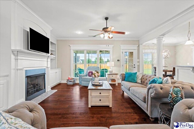 3106 Wainwright Ct, Florence, SC 29501 - living area featuring dark wood-type flooring, ceiling fan, healthy amount of natural light, crown molding, and a fireplace