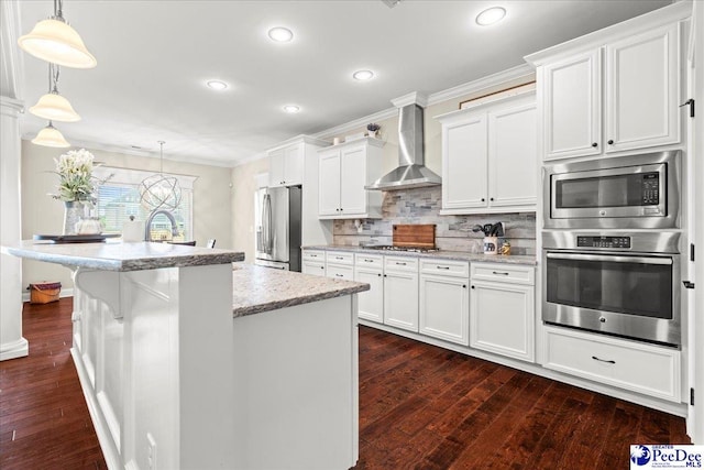 3106 Wainwright Ct, Florence, SC 29501 - kitchen featuring appliances with stainless steel finishes, wall chimney range hood, ornamental molding, dark wood-type flooring, and white cabinets