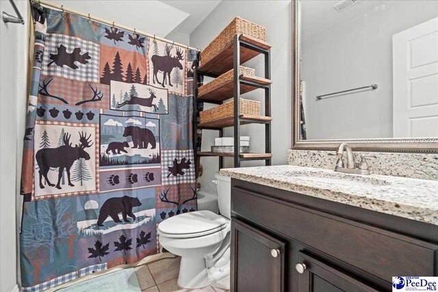 3106 Wainwright Ct, Florence, SC 29501 - bathroom featuring vanity, toilet, tile patterned flooring, and curtained shower