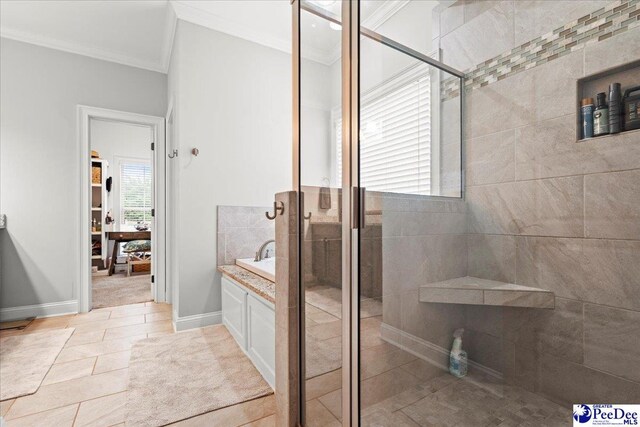 3106 Wainwright Ct, Florence, SC 29501 - bathroom featuring ornamental molding, a stall shower, vanity, baseboards, and tile patterned floors