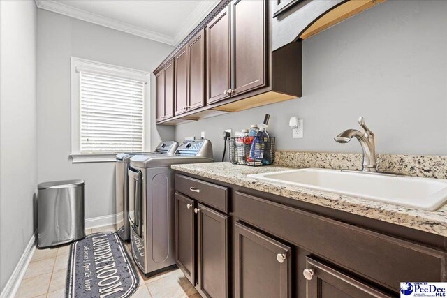 3106 Wainwright Ct, Florence, SC 29501 - laundry area with separate washer and dryer, cabinet space, ornamental molding, light tile patterned floors, and baseboards