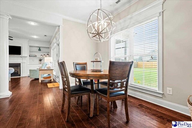 3106 Wainwright Ct, Florence, SC 29501 - dining space with baseboards, a chandelier, wood-type flooring, crown molding, and a fireplace
