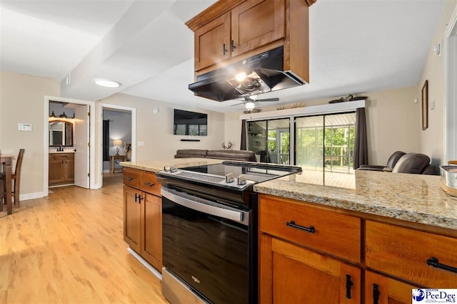 2963 Miss Annie Ct, Gresham, SC 29544 - kitchen with brown cabinetry, a ceiling fan, under cabinet range hood, and stainless steel electric range oven