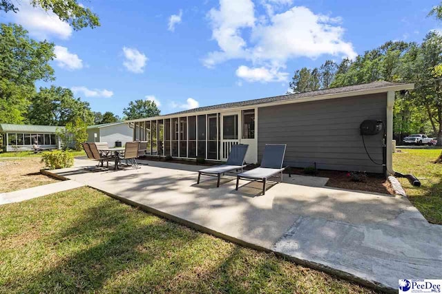 2963 Miss Annie Ct, Gresham, SC 29544 - back of house featuring a yard, a sunroom, and a patio area