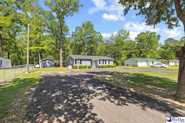 2963 Miss Annie Ct, Gresham, SC 29544 - view of front of home with fence, an outbuilding, driveway, and a front lawn