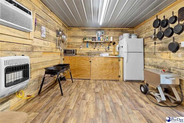 2963 Miss Annie Ct, Gresham, SC 29544 - kitchen featuring freestanding refrigerator, wooden walls, heating unit, and a sink
