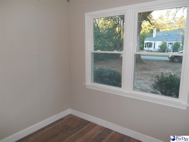 empty room with dark hardwood / wood-style floors