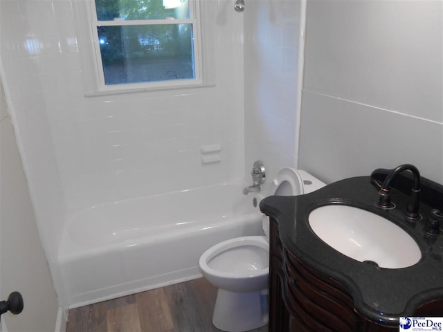 full bathroom with shower / washtub combination, toilet, hardwood / wood-style floors, and vanity