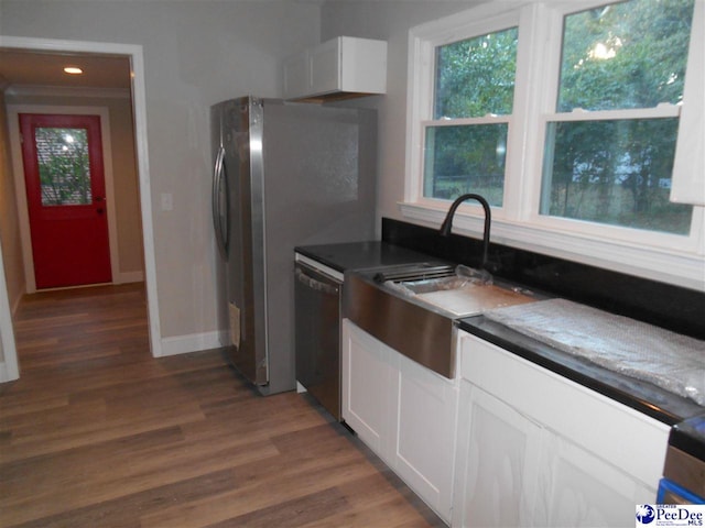 kitchen with white cabinetry, appliances with stainless steel finishes, dark hardwood / wood-style flooring, and sink