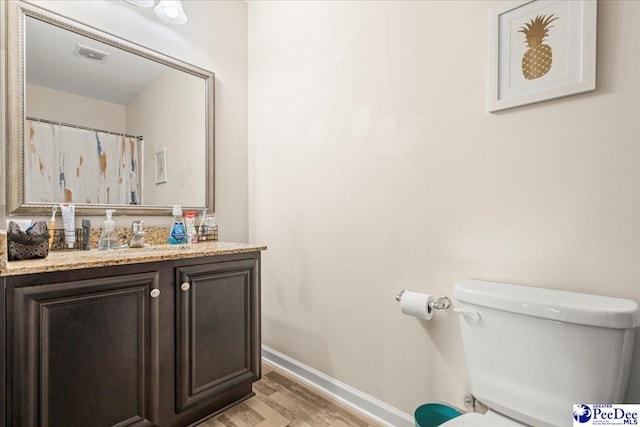 1200 Turtle Dove Dr, Effingham, SC 29541 - full bathroom featuring wood finished floors, toilet, vanity, and baseboards