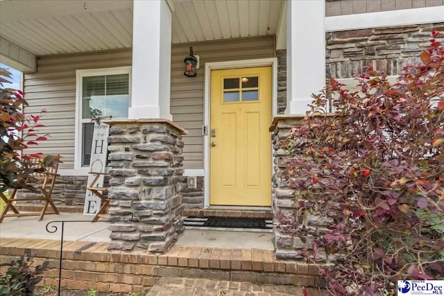 1200 Turtle Dove Dr, Effingham, SC 29541 - view of exterior entry featuring a porch and stone siding