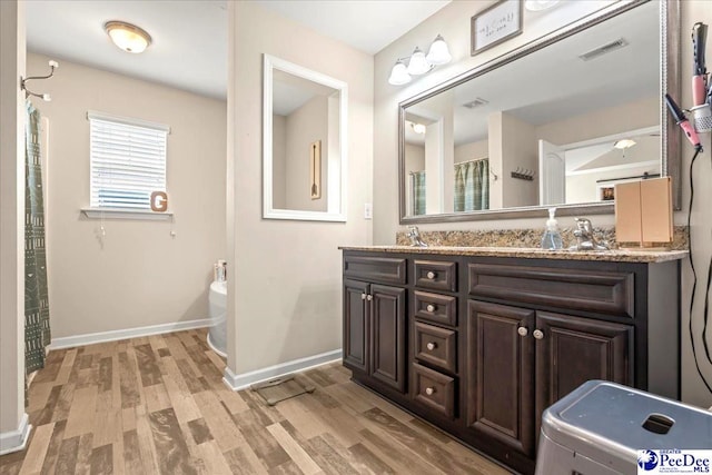 1200 Turtle Dove Dr, Effingham, SC 29541 - full bathroom with double vanity, wood finished floors, curtained shower, a bath, and baseboards