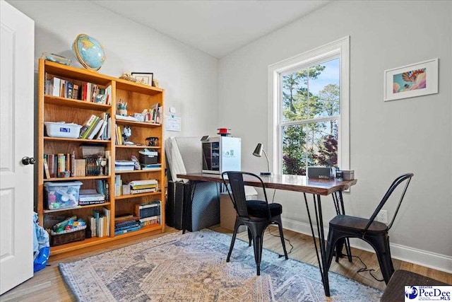office with baseboards and wood finished floors