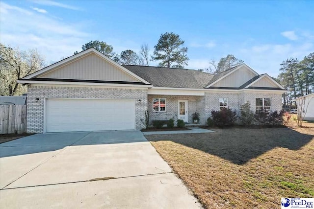view of front of house featuring brick siding, a front lawn, concrete driveway, and a garage