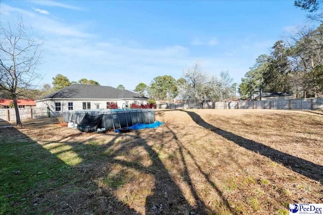 view of yard with a fenced in pool and a fenced backyard