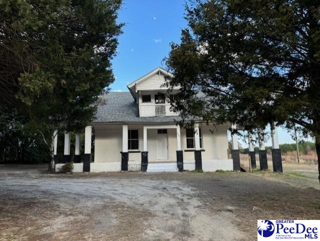 view of front of home with a balcony and covered porch