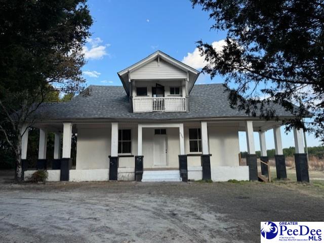 view of front of home featuring a porch and a balcony