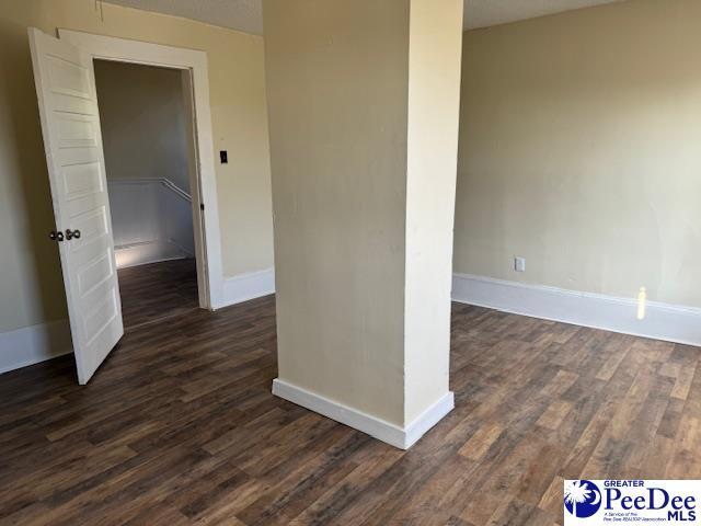 spare room with dark hardwood / wood-style flooring