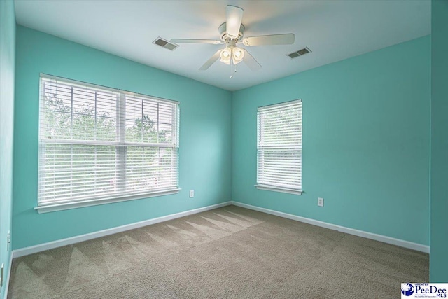 spare room with light carpet and ceiling fan