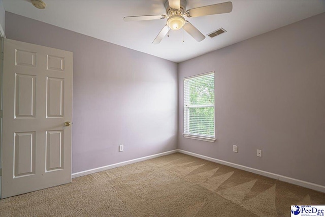 carpeted spare room with ceiling fan