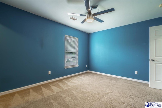 carpeted spare room with ceiling fan