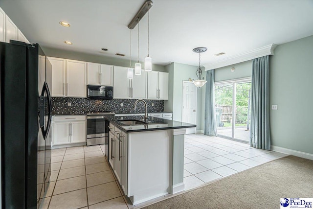 kitchen featuring a kitchen island with sink, sink, white cabinets, and black appliances