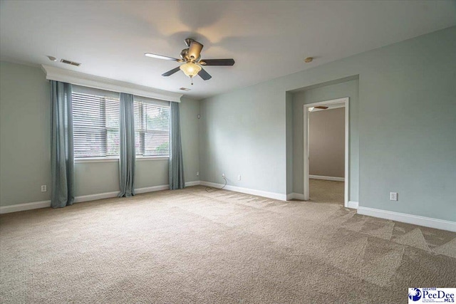 carpeted spare room with ceiling fan