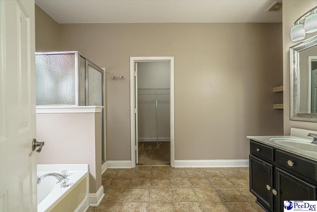 bathroom featuring vanity and separate shower and tub