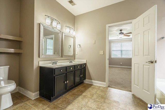 bathroom featuring vanity, ceiling fan, and toilet