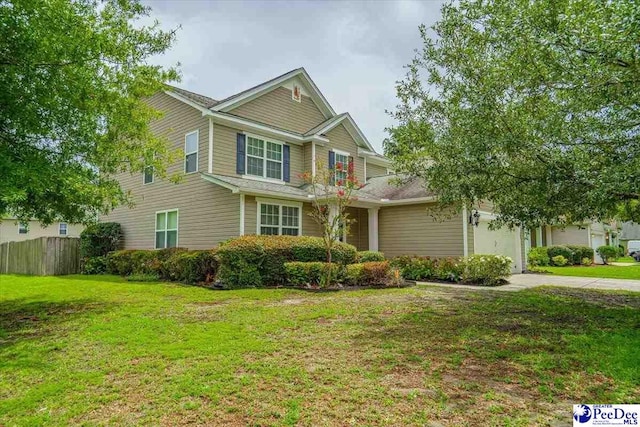 view of front of house with a garage and a front lawn