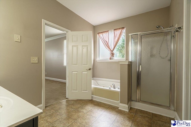 bathroom with vanity, lofted ceiling, and shower with separate bathtub